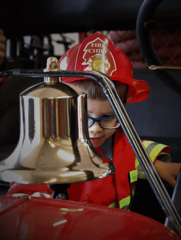 CHILD LOOKING AT BELL